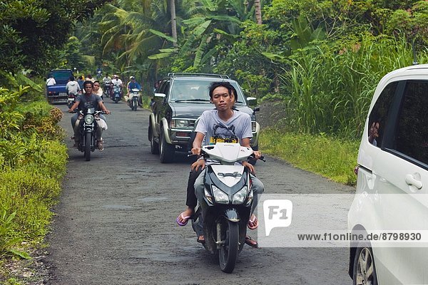 Busy traffic  typical of Java's now clogged roads  near the south coast resort town of Pangandaran  West Java  Java  Indonesia  Southeast Asia  Asia