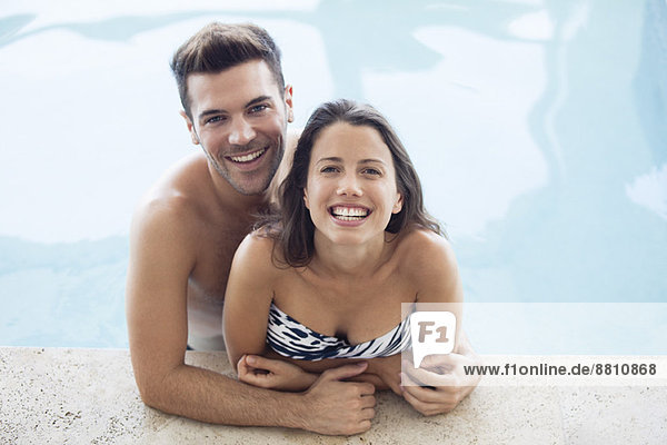 Young couple in pool together  portrait