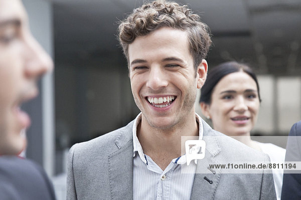 Businessman laughing with colleagues