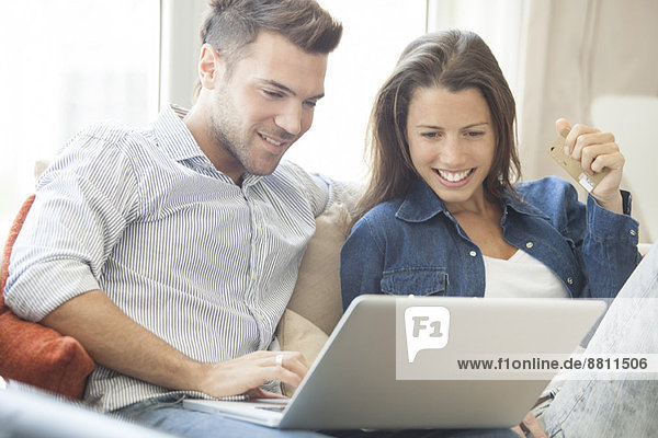 Couple at home shopping online together