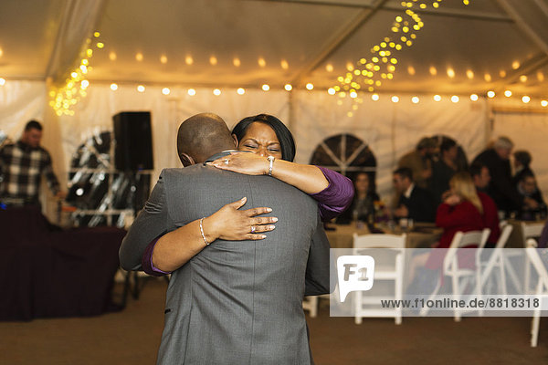 Groom dancing with mother at reception