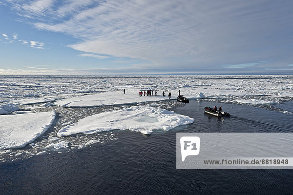 Tourists taken in inflatable boats onto an ice floe  pack ice  Arctic Ocean  Spitsbergen Island  Svalbard Archipelago  Svalbard and Jan Mayen  Norway