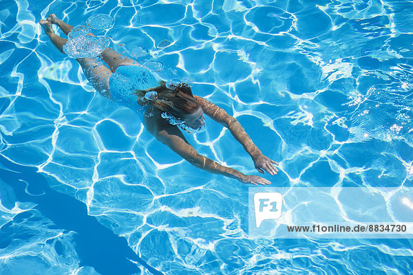Italy,  woman diving in swimmingpool