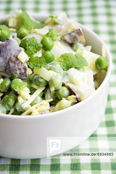 Minted pea and potato salad in bowl