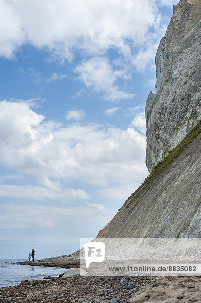 Denmark  Mon island  mother and daughter walking below Mons Klint chalk cliffs