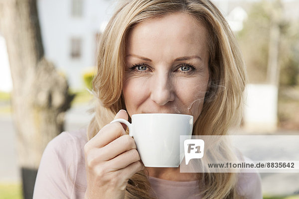 Portrait of woman drinking cup of coffee  close-up