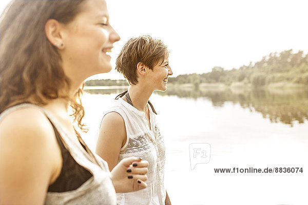 Porträt von zwei jungen Frauen  die sich am Baggersee amüsieren