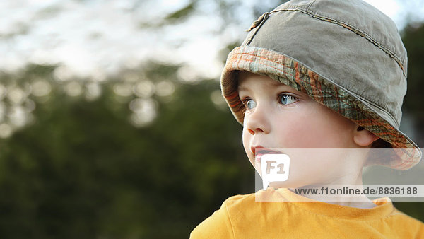 Portrait of little boy playing wearing sun hat