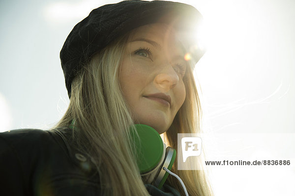 Young woman with cap and head phones  portrait