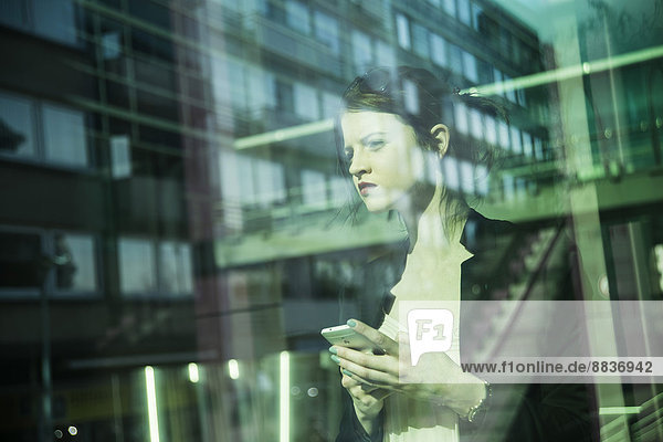 Portrait of young business woman with smartphone