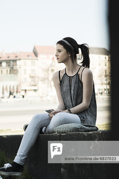 Portrait of young woman with smartphone