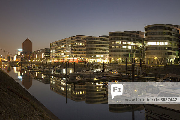 Germany North Rhine-Westphalia Duisburg Inner harbour and office buildings Five Boats by night