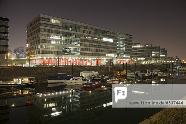 Germany North Rhine-Westphalia Duisburg Hitachi Power Office and Marina by night