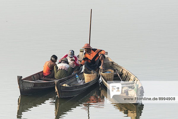 Fishermen in their boats in the morning light Thaungthaman Lake Amarapura Mandalay Division Myanmar