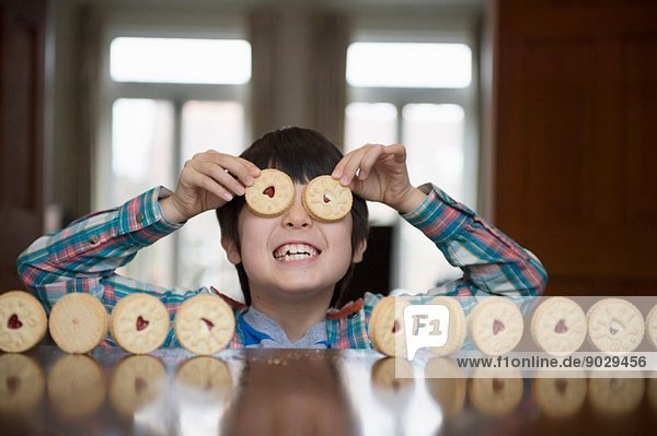 Boy playing with biscuits