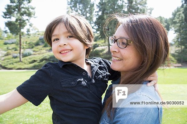 Portrait of mother and son in park
