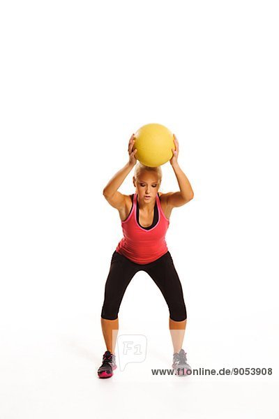 Young woman exercising with ball  studio shot