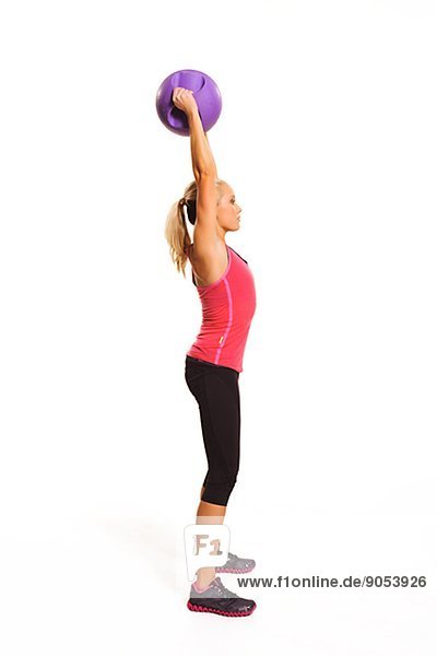 Young woman exercising with ball  studio shot