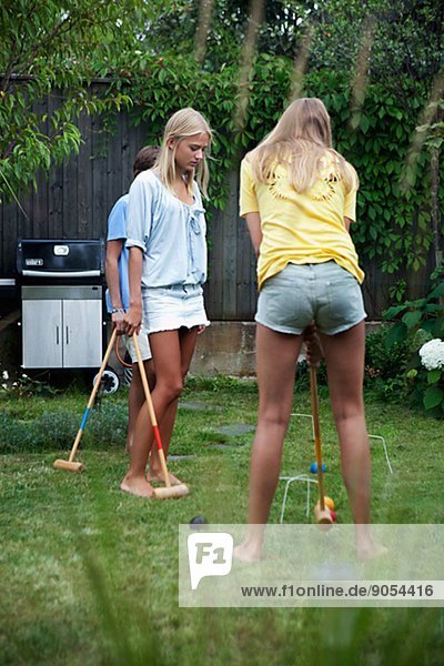 Teenagers playing croquet in garden  Sweden