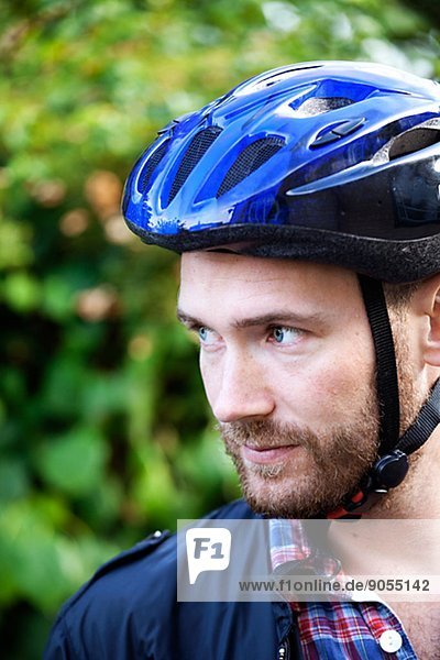 Mid adult man wearing cycling helmet  Sweden