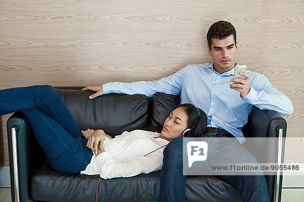 Young couple sitting on sofa  Bangkok  Thailand