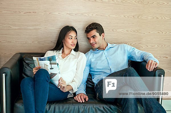 Young couple sitting on sofa  Bangkok  Thailand
