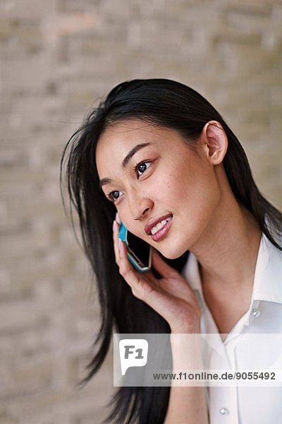 Young woman talking via cell phone