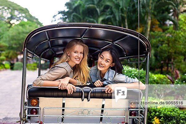 Young women on rickshaw  Bangkok  Thailand