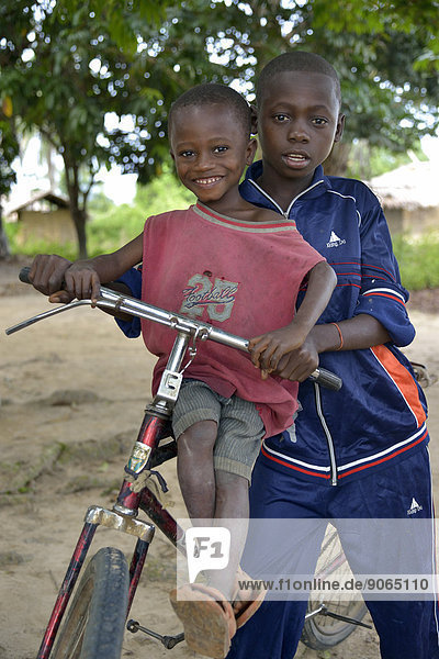 Two children with a bicycle  Nkala  Bandundu Province  Democratic Republic of the Congo