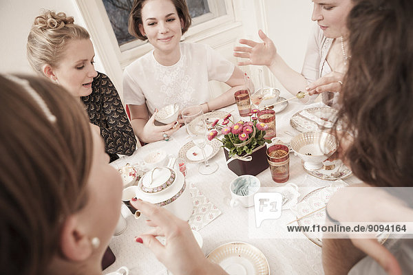 Young women on a retro style tea party