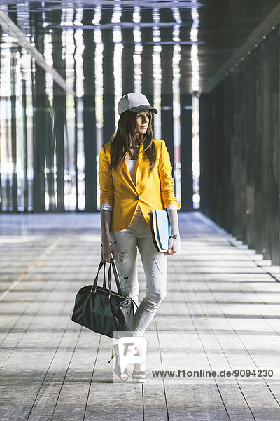 Spain Catalunya  Barcelona  young modern businesswoman with yellow jacket on the move
