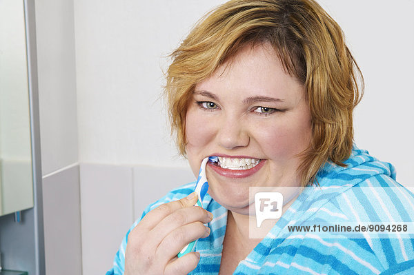 Germany  Mid-adult woman brushing teeth