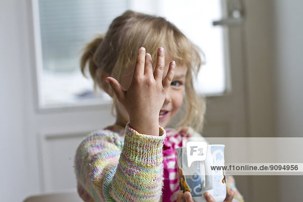 Portrait of little girl counting with fingers
