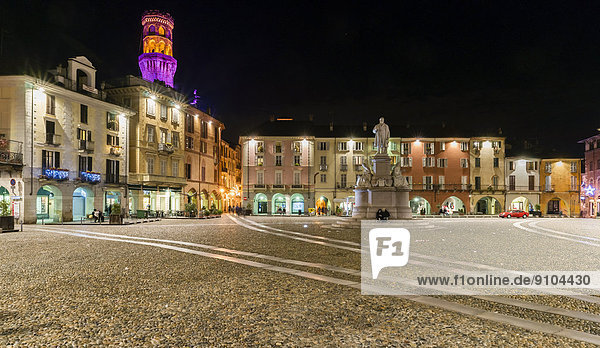 Piazza Cavour with the illuminated Torre the Angel or Angel Tower  Monument to Camillo Benso Conte di Cavour  at night  Vercelli  Piedmont  Italy