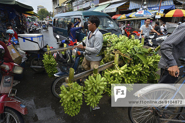 Banana seller with a moped  market  Phnom Penh  Cambodia