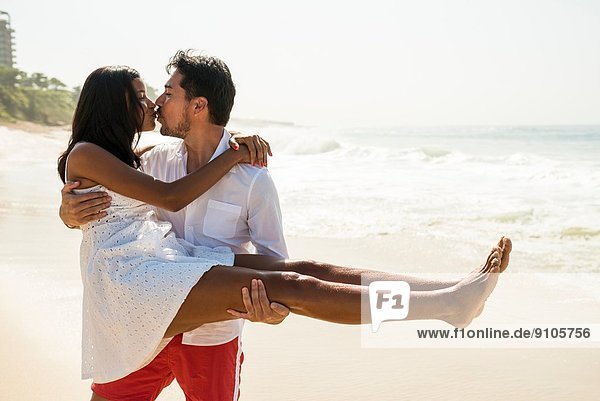 Couple kissing on Arpoador beach  Rio De Janeiro  Brazil