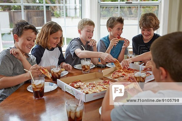 Group of boys sharing pizza