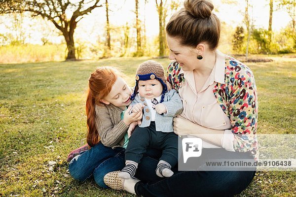Mid adult mother daughter and baby son in park