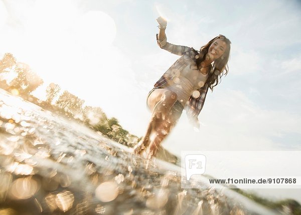 Young woman paddling in lake