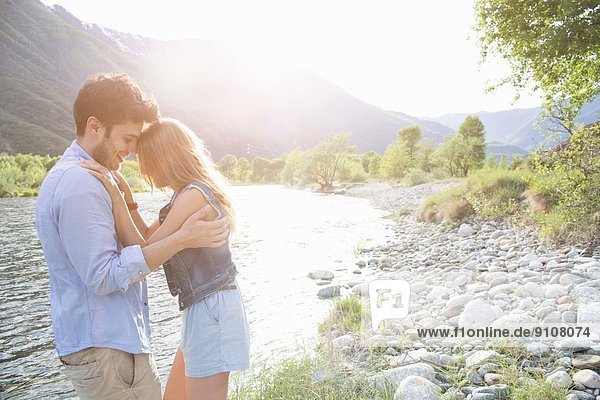 Young couple hugging on Toce riverbank  Piemonte  Italy