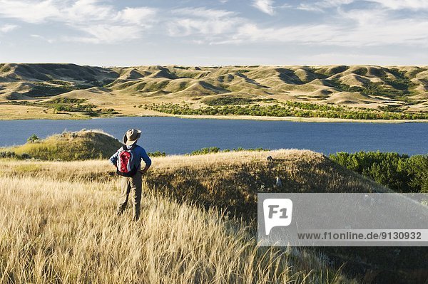 hiker  Saskatchewan Landing Provincial Park with Lake Diefenbaker in the background  Saskatchewan  Canada