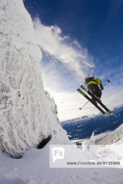 A male skier catches some air off a cliff in the Revelstoke Mountain Resort  Revelstoke Backcountry  BC