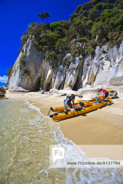 Kayakers on the beach at Arch Point  Abel Tasman National Park  Tasman District  South Island  New Zealand
