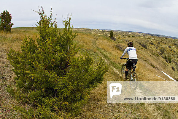 A male mountain biker enjoys the beautiful singletrack of the Maah Daah Hey Trail  North Dakota