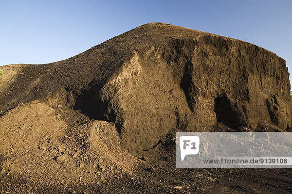 Mound of topsoil in a commercial sandpit  Quebec  Canada.