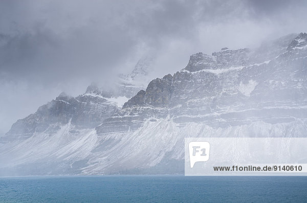 Snow storm over Bow Lake and Crowfoot mountain in Banff National Park  Alberta  Canada.