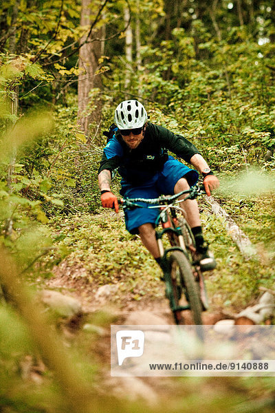 A young male mountain biker riding the Moonraker cross country trail system near Golden  BC