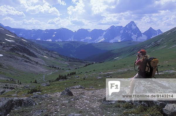 Woman photographer overlooking Ptarmigan Valley  Purcell Mountains  British Columbia  Canada