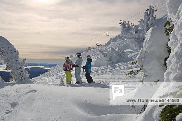 A family gets ready for the next run  Sun Peaks Resort  Sun Peaks  British Columbia  Thompson Okanagan region  Canada.