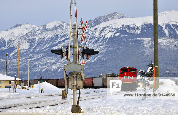 A Canadian National freight train traveling through the town of Jasper in Jasper National Park Alberta Canada.
